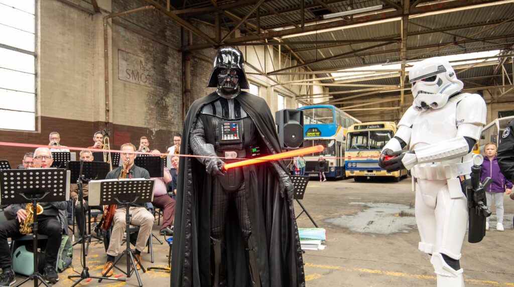 Lord Vader cuts the ribbon with a thrust of his lightsaber
