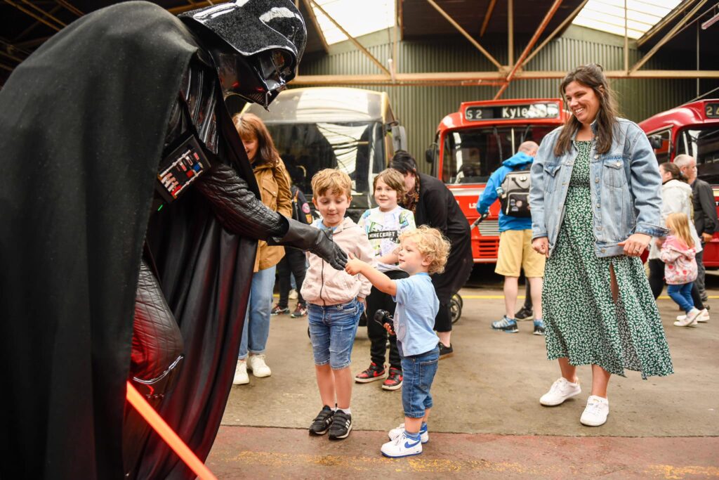 The short and the tall as Darth Vader greets a special young fan at Family Day