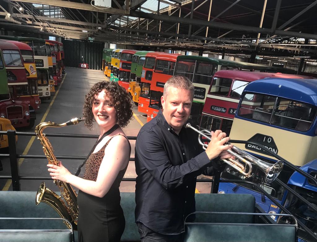 Musical buses … band members Olivia Calder and Gary Mitchell at Bridgeton Garage